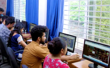 Students working on architectural model by using computer