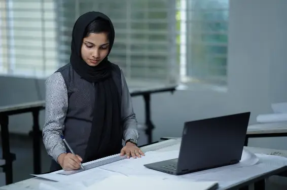 Interior design student diligently crafting an interior plan on a drafting table